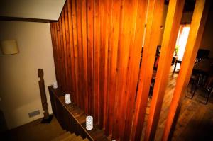 a wooden wall in a living room next to a staircase at Resataurant and Rooms Cabrit in Sant Mateu