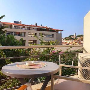 a table on a balcony with a cup on it at Le Petit Château - Cannes in Cannes