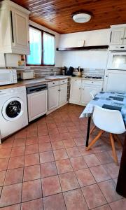 a kitchen with a table and a washing machine at Les Champs d'Opale in Bréxent-Énocq