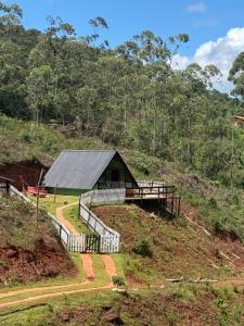 a house on the side of a hill at CHALÉS VILA RICA - Bar do Ricardo in Ouro Preto