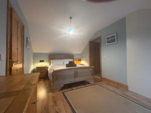 a bedroom with a bed and a table in it at Skellig Sanctuary in Dingle