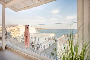 a balcony with a view of the ocean at Coral Hotel - Hotelia Hospitality Group in Ierapetra