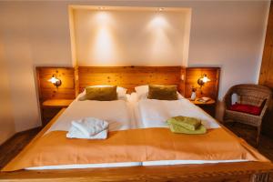 a bedroom with a bed with two towels on it at Almenlandhof in Fladnitz an der Teichalm