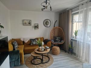 a living room with a couch and a table at PIK-Kwatery in Morąg