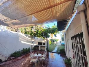 a patio with tables and chairs in a building at La Oliva in San Martín