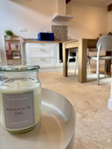 a jar of candle sitting on a table in a room at L'Écrin Rustique in Couzeix +5 photos