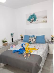 a bedroom with a bed with toys on it at La magia del sur 2 in Cádiz +15 photos