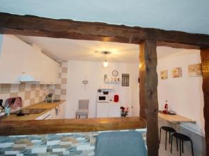 a kitchen with a table and chairs in a room at La magia del sur 2 in Cádiz