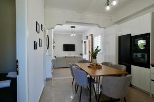 a dining room and living room with a table and chairs at BellaDiAnna Apartment in Symi
