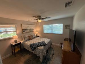 a bedroom with a bed and a ceiling fan at 1008 Gardens in Vero Beach