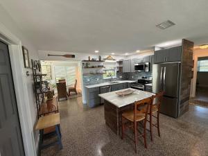 a kitchen with a table and some chairs in it at 1008 Gardens in Vero Beach