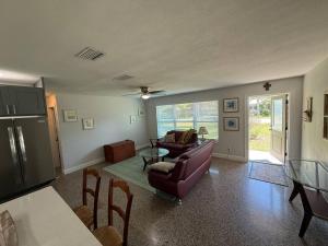 a living room with a couch and a table at 1008 Gardens in Vero Beach