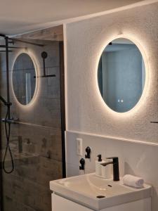 a bathroom with a sink and a shower at Old City Apartment Möckmühl in Möckmühl