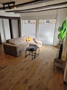 a living room with a couch and a table at Old City Apartment Möckmühl in Möckmühl