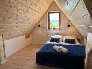 a bedroom with a bed in a attic at Kobakówka in Krynica Zdrój
