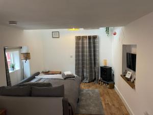 a living room with a bed and a couch at Yew Trees Barn in Backwell