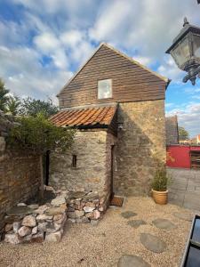 a stone building with a window on top of it at Yew Trees Barn in Backwell