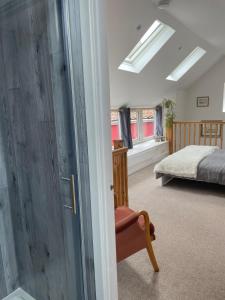 a bedroom with a bed and a sliding glass door at Yew Trees Barn in Backwell