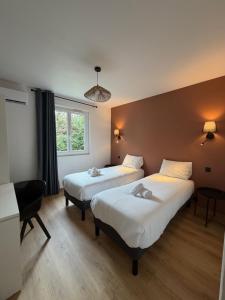 a room with two beds and a window at Le Moulin de Barette - Blavozy, 43700 Le Puy-en-Velay in Blavozy +28 photos