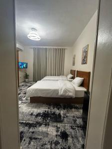 a hotel room with a bed and a window at Terra Pyramids Hotel in Cairo