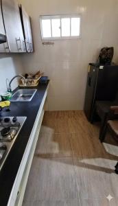 a kitchen with a sink and a stove in it at Apartamento Paraiso Nuquí in Nuquí +17 photos