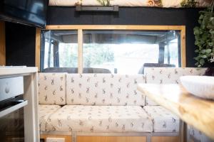 a living room with a couch and a table at Parrys Horse box in Exmouth