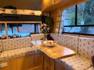 a small table with a bowl of fruit on it at Parrys Horse box in Exmouth
