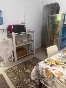a kitchen with a table and a tv in a room at Airport home stay in Ekala