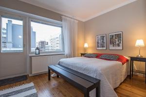 a bedroom with a bed and a large window at Apartment Savonkatu 25 in Kuopio