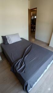 a bed with a blue blanket on the floor in a room at Apartamento Paraiso Nuquí in Nuquí
