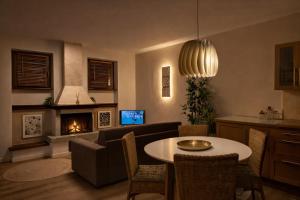 a living room with a table and a fireplace at Casa Cinzia in Gravedona