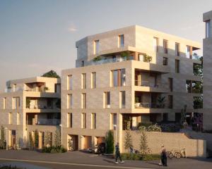 a building with people walking in front of it at Apartment in Central Røa Oslo by the Train Station in Oslo
