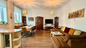 a living room with a couch and a table at Gael Stary Rynek 1 in Elblag