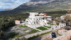 an aerial view of a large white house with mountains in the background at Mani Tigani View Studio in Kafióna