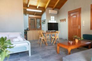 a living room with a couch and a table at Mani Tigani View Studio in Kafióna