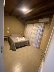 a bedroom with a bed in a room with a window at El Atardecer Complejo Turístico in San Rafael +35 photos