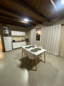a kitchen with a table and chairs in a room at El Atardecer Complejo Turístico in San Rafael