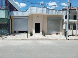 a house with two garage doors on a street at Room #2 donde Alice in San Miguel
