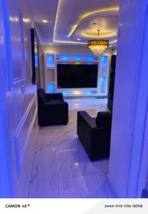 a living room with two couches and a flat screen tv at Ngalle guest house in Buea