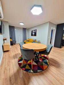 a room with a table and chairs and a couch at By The Pool Apartments #8 in Velingrad +3 photos