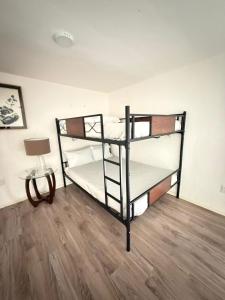 two bunk beds in a room with a table at Casa Alhaja - Diamante in Guadalajara +26 photos