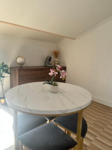 a white marble table with a potted plant on it at Escapade Chic in Renwez +7 photos