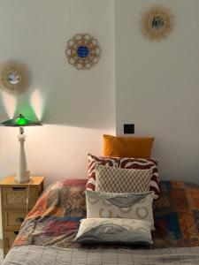 a bedroom with a bed with a pile of pillows at 13th private in Rueil-Malmaison