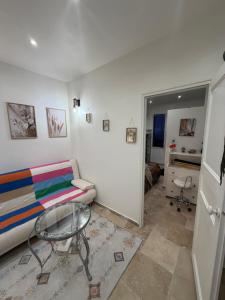 a living room with a couch and a table at 13th private in Rueil-Malmaison