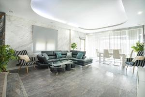 a living room with a couch and a table and chairs at Villa Jazmín - Piscina - BBQ - Jardín - Chill out in Masía Aldamar