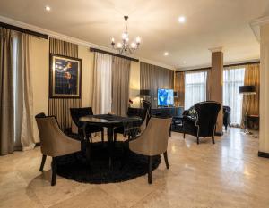 a living room with a dining room table and chairs at Villa Monticello Boutique Hotel in Accra