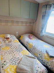 two beds sitting next to each other in a bedroom at Riverside 24 - Haggerston Castle in Berwick-Upon-Tweed +34 photos