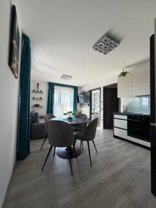 a kitchen and living room with a table and chairs at Minimál Éden in Balatonlelle