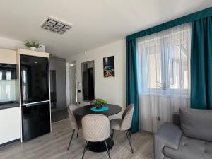 a living room with a table and chairs and a couch at Minimál Éden in Balatonlelle