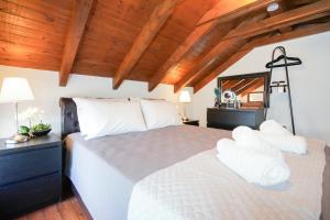 a bedroom with a large bed with white pillows at Aegean Balcony Apartment in Nea Peramos